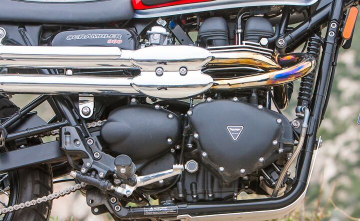 scrambler slam ducati vs triumph video, The Triumph s high pipes do more than just look cool when navigating around and over off road obstacles The Trumpet also wears a bash plate below its frame rails and carries 0 6 gallons more fuel 4 2 gal Triumph vs 3 6 gal Ducati