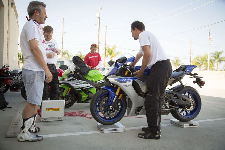 2015 six way superbike track shootout video, While Evans Sean and Kevin weigh each bike Burns is busy staring at something shiny off in the distance
