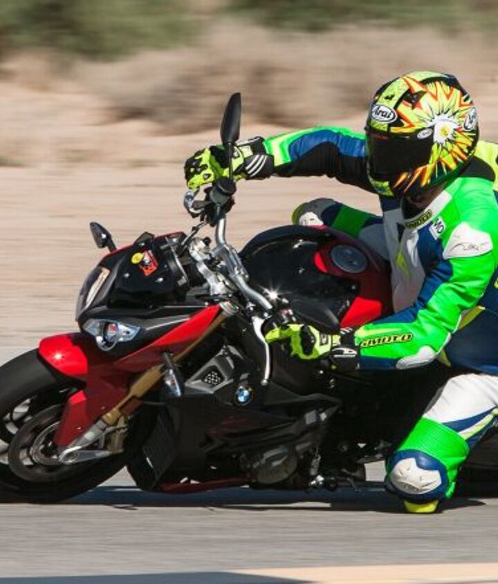 2017 supernaked streetfighter shootout, The S1000R encouraged rapid transitions and the pressing of its mid corner traction note the squeezed front brake lever and how much front suspension travel is currently being used as the BMW is trail braked into this corner It really does encourage and allow its rider to press it right up to the limits of adhesion However not long after this photo was taken Sean would take a step too far in a slow right hander and learn just how forgiving the big BMW really could be as he tucked the front and then picked the bike up off his knee mid crash before riding out of it Moral of the story take it easy at the track on stock street tires