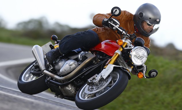 2016 triumph bonneville thruxton r first ride review, An ear pleasing sound emanates from the dual upswept reverse cone mufflers Too bad Triumph couldn t have budgeted for removing the unsightly tank seam