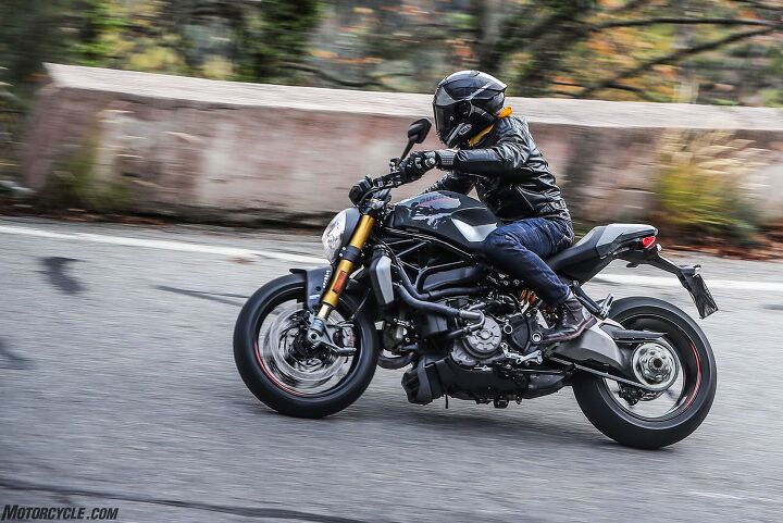 2017 ducati monster 1200s first ride review, The busy left side of the Monster 12 makes us pine for the uncluttered look of the air cooled original Monsters A large pair of rubber coolant hoses radiator and a smattering of plastic covers detract from the Ducati s style The liquid cooled price of performance progress