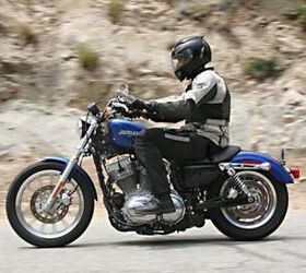 shootout 2010 honda shadow rs vs 2010 harley davidson 883 low, The H D readily drags its exhaust on right handed turns