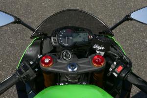 2013 kawasaki ninja zx 6r review motorcycle com, An analog tachometer dominates the gauge cluster while the digital LCD screen displays a variety of information Adjustments to Showa s SFF BP fork are easily made with all the clickers conveniently placed atop the fork caps Note also the power and KTRC toggle on the left switchgrip