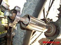 mo s trip to usgp 2007, This old deep socket is attached by some random bolts and whatnot welded together Simply flip the socket against the sidewall of the tire and the bike s ready for power One of two brake levers now serves as the throttle to the weed whacker Apply the brakes Go faster