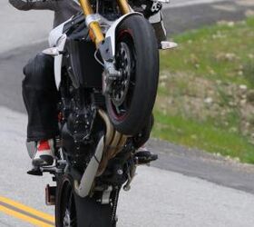 2012 triumph speed triple r review motorcycle com, No Speed Triple review would be complete without a gratuitous wheelie shot