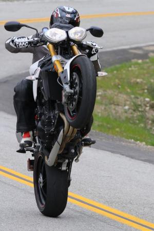 2012 triumph speed triple r review motorcycle com, No Speed Triple review would be complete without a gratuitous wheelie shot