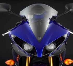 2012 yamaha yzf r1 review video motorcycle com, Changes to the headlight cowl come in the form of larger LED position lamps at the outer edges and reflectors on the lower portion of the fairing Minor changes but they give the R1 a more aggressive look