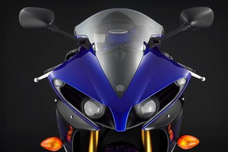 2012 yamaha yzf r1 review video motorcycle com, Changes to the headlight cowl come in the form of larger LED position lamps at the outer edges and reflectors on the lower portion of the fairing Minor changes but they give the R1 a more aggressive look