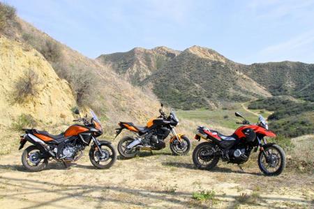 2012 650 adventure tourer shootout video motorcycle com, The Kawasaki Versys BMW G650GS and Suzuki V Strom 650 ABS blend everyday livability with a willingness to seek out roads less known Price tags below 10 000 are a nice bonus too