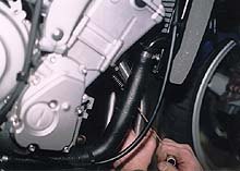 the gms exhaust system for the yamaha yzf r6, Here a spring puller is being employed to connect the outside spring to the head pipes This system of installation can be much easier to deal with than head pipes that bolt directly to the manifold