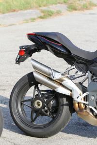 2012 mv agusta brutale r 1090 review motorcycle com, The Brutale boasts alluring lines and a gorgeous single sided swingarm but those super stylin pipes get in the way of a rider s right foot