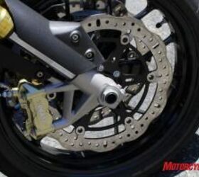 2010 aprilia dorsoduro 750 vs ducati hypermotard 796 motorcycle com, The Dorsoduro s Aprilia branded four piston radial mount brakes and wave style rotors provided just as much power but a better level of feel than the Hyper s Brembo brakes