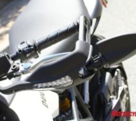 2010 aprilia dorsoduro 750 vs ducati hypermotard 796 motorcycle com, Slim LED turn signals integrated into hand guards and folding bar end mirrors are a carryover from the 796 s bigger brother the Hypermotard 1100
