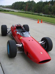 manufacturer seeing red world champ fourwheeler gets bobberized 42677, A view of a 1964 Ferrari 158 like that used by World Champion motorcycle roadracer John Surtees to win the 1964 F1 title becoming the only racer to have won world championships on two wheels and four