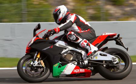 2011 aprilia rsv4 factory aprc se review motorcycle com, You can bet there s a big smile hidden behind that tinted visor as he whips this high tech rocket around Jerez