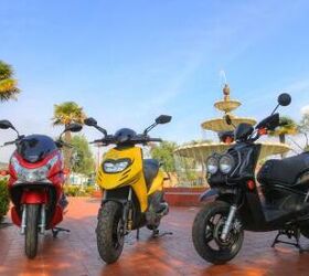 2012 125cc scooter shootout video motorcycle com, The Honda PCX left Piaggio Typhoon 125 middle and Yamaha Zuma 125 represent three similar but distinct methods to providing simple and economical transportation