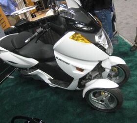 2011 indy dealer expo report, Electric scooter manufacturer Vectrix showed of its new VX 3 with Piaggio MP3 like tilting dual front wheels It s currently being evaluated by the LAPD