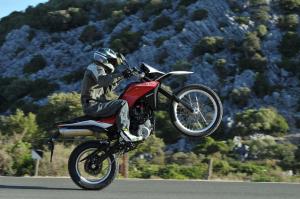 2013 husqvarna tr650 review motorcycle com, With a fairly tall center of gravity and more than 50 horses making their way to the rear tire the TR650 loves to wheelie