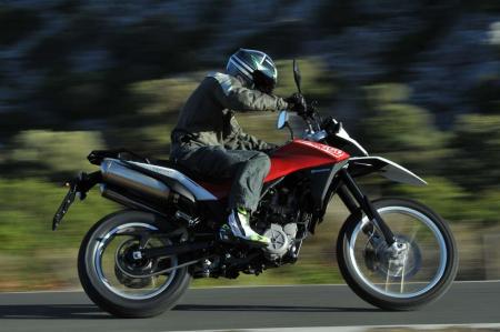 2013 husqvarna tr650 review motorcycle com, The TR650 s nimbleness and balanced chassis deliver solid on road performance for a dual sport