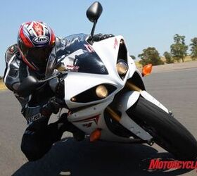 2009 yamaha r1 review motorcycle com, Unlike most sportbikes dual headlamps both of the R1 s projector headlights remain lit in both high and low beams