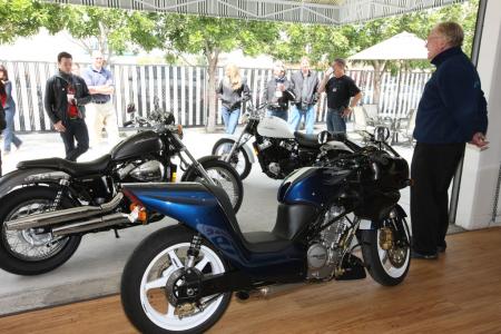 2010 honda shadow rs review motorcycle com, Our ride consisted of a stop over at Dan Gurney s All American Racers shop museum in Santa Ana Gurney far right peruses the Shadow RS while his Alligator A6 sits in the foreground