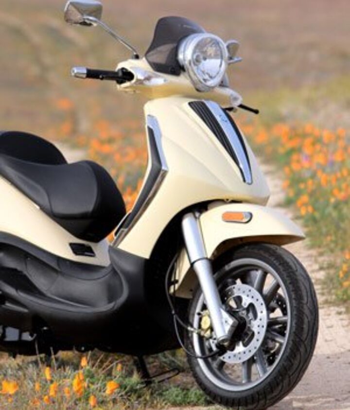 2009 piaggio bv500 scooter review motorcycle com, High stepping through the poppies the BV500 sports a 41mm front fork dual disc brakes up front and plenty of chrome accents