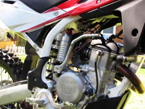 2010 husqvarna tc 250 review motorcycle com, Simple is good The new engine is tiny almost the size of a 125 two stroke Everything on the Husky was designed to be easy to access