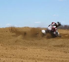2010 husqvarna tc 250 review motorcycle com, The Husky handles great Liam O Farrell drags the bars through a sandy turn at warp factor nine for the Motorcycle com lens