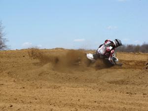 2010 husqvarna tc 250 review motorcycle com, The Husky handles great Liam O Farrell drags the bars through a sandy turn at warp factor nine for the Motorcycle com lens