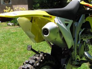 2010 suzuki rmx450z review motorcycle com, The RMX is choked up big time Lose the EPA stuff and it becomes a different bike but it also gets loud and technically illegal to operate on public land