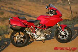 church of mo 2009 ducati multistrada 1100 s review, The standard model seen here with accessory hard luggage is no longer available in the U S leaving the S model with Ohlins front and rear and various carbon bits as the only Multitrada for 2009 Both models share the same frame and engine