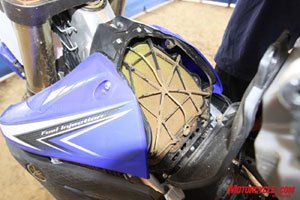 2010 yamaha yz450f review motorcycle com, Two days of riding and 8 quick bolts get you inside the relocated airbox for cleaning