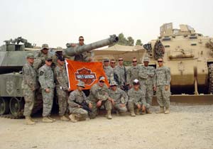 featured motorcycle brands, A military unit displays the flag they received from Harley Davidson