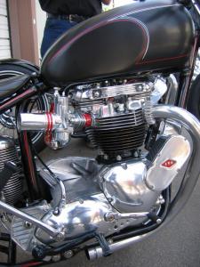 when triumphs go bad, The Kane built Bonneville motor features a classic ARD magneto and true to old school Amal carbs with a glimpse of the hand formed finned oil tank and we don t need no stinkin mufflers exhaust system