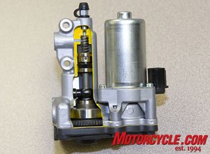 2009 honda cbr600rr c abs review motorcycle com, Cut away of the power unit The exposed modulator piston is what applies fluid pressure back through the valve unit and out to the calipers