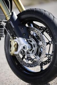2012 aprilia dorsoduro 1200 review motorcycle com, New wheels contribute to the majority of the Dorso s weight loss plan Stopping power is strong as ever with the Brembo calipers Note the ABS ring within the rotor