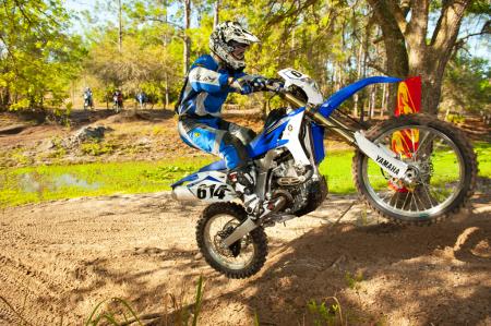 2012 yamaha wr450f review motorcycle com, Throttle response makes lifting the front end easier than previous versions of Yamaha s WR With its lower seat height and less stink bug feel the WR is more usable in all technical trail situations