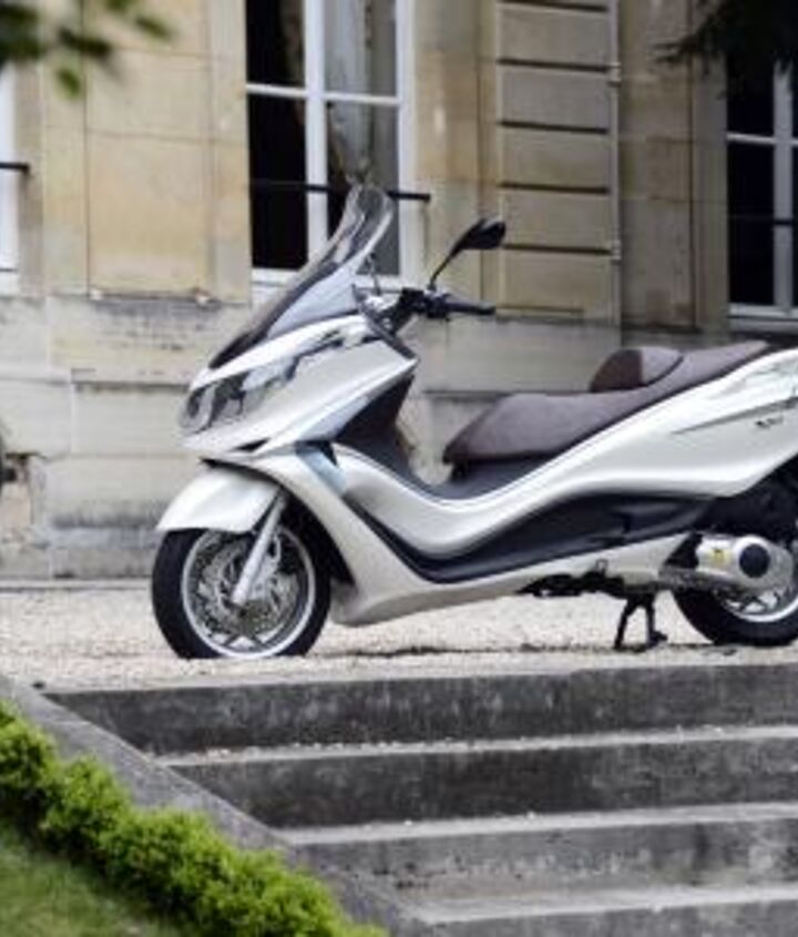 2012 piaggio x10 350 review motorcycle com, The Italian Embassy in Paris offers an elegant backdrop for the launch of the Piaggio X10 the Italian manufaturer s new flagship maxi scooter