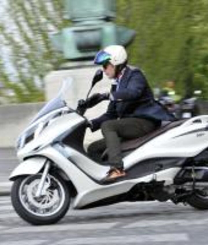 2012 piaggio x10 350 review motorcycle com, The rudimentary traction control system proved to be a bit obtrusive on the wet streets and riding over painted lines