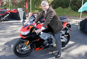 piaggio s ceo speaks out on state of motorcycling, In a lighter moment Timoni straddled one of his company s hottest products at Aprilia s media open house in Costa Mesa