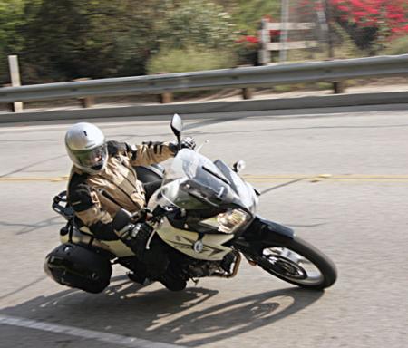 suzuki v strom 2011 review 2012 preview, The V Strom plays the role of sportbike quite well considering its tall stature Its top heavy looks belie its transitioning prowess