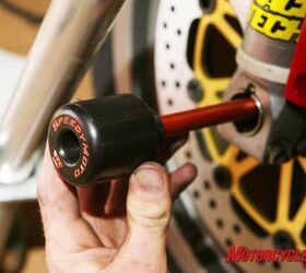 road racing series part 7, These front axle sliders by Speedy Moto keep critical front end parts like rims forks and braking components from contacting the pavement in the event of a crash Photo by Holly Marcus