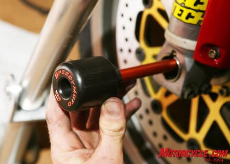 road racing series part 7, These front axle sliders by Speedy Moto keep critical front end parts like rims forks and braking components from contacting the pavement in the event of a crash Photo by Holly Marcus