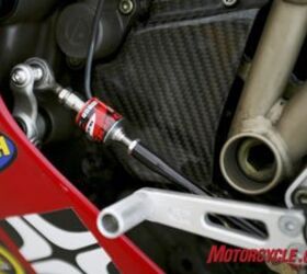 road racing series part 7, Dynojet s Quick Shifter replaces the linkage on stock or aftermarket shifters and interfaces easily with a Power Commander cutting the ignition to provide full power clutchless upshifts Photo by Holly Marcus