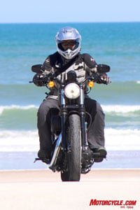 2009 harley davidson iron 883 review motorcycle com, Like a phoenix rising from the south Fonzie trades in the KLR for a Dark Custom and hits the strand looking for babes Sorry Fonz I don t see any girls in this picture Ed