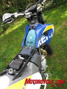 2010 husaberg fe570 review motorcycle com, The airbox and electrics are incredibly easy to access by pulling a rip cord underneath the seat
