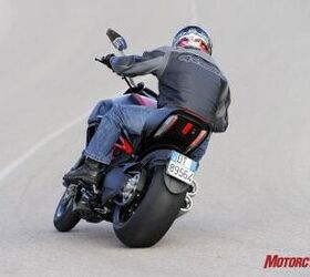 2011 ducati diavel review motorcycle com, Holy 240 tire Batman The minimalist license plate holder attaches to the left side of the single sided swingarm and uses a bright but small LED to illuminate the number plate