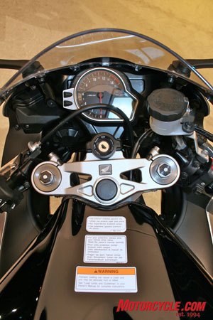 first look 2008 honda cbr1000rr motorcycle com, The much more modern looking instrument cluster cleans up the cockpit Can you find the HESD You can t see it because it s tucked neatly out of sight under the fuel tank shell