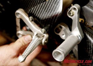 road racing series part 8, OEM foot pegs are replaced by aftermarket rearsets These Woodcraft rearsets featured a round knurled peg for positive traction in various body positions and is non folding to add protection in case of a crash Photo by Holly Marcus