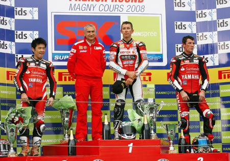 featured motorcycle brands, Davide Tardozzi second from the left stands on the podium with three of his former riders from left Noriyuki Haga Troy Bayliss and Troy Corser Tardozzi and Corser will be reunited in 2010 with BMW